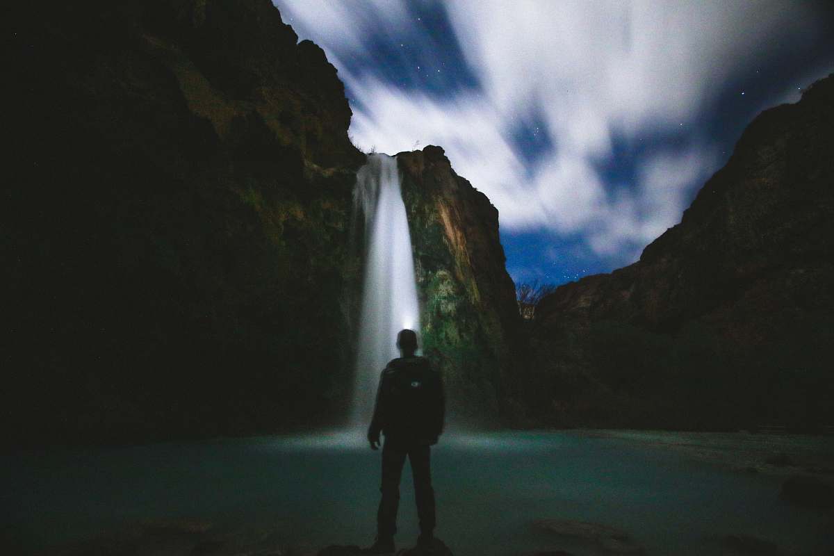 havasu falls man standing in front of body of water standing